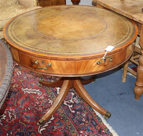 A William Tillman Regency style drum table having leather skiver over four drawers W.92cm